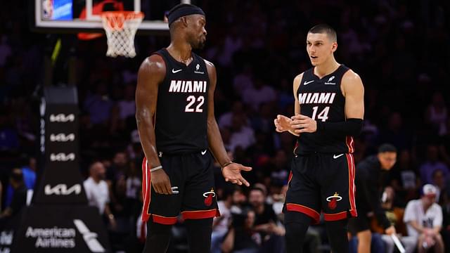 Miami Heat forward Jimmy Butler (22) and guard Tyler Herro (14) talk on the court against the New York Knicks during the second quarter at Kaseya Center.