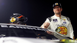 Jul 20, 2024; Hampton, VA, USA; Dale Earnhardt Jr. waits next to his during qualifying for the 16th Annual Hampton Heat at Langley Speedway. Mandatory Credit: Peter Casey-Imagn Images