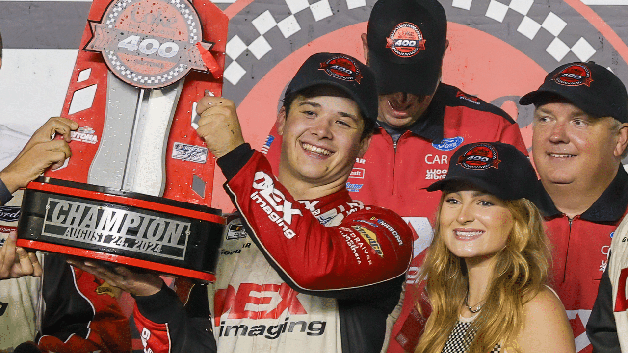 NASCAR Cup Series driver Harrison Burton (21) holds up the trophy after winning the Coke 400 at Daytona International Speedway.