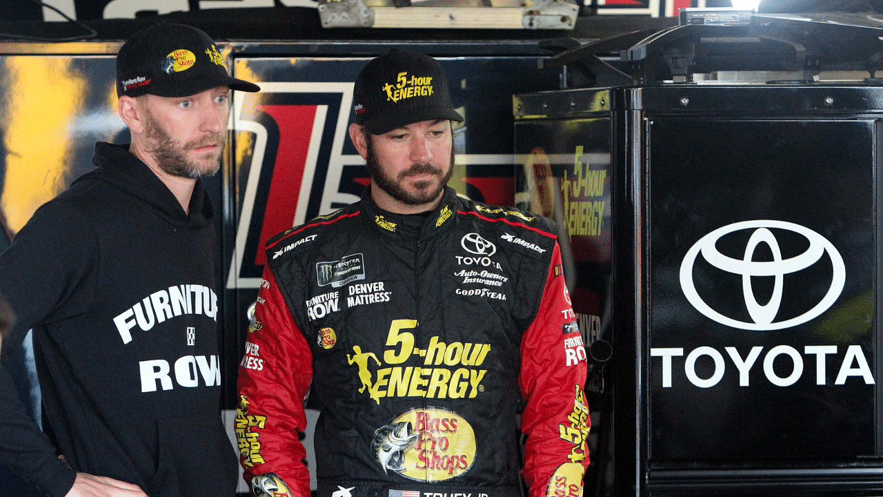 NASCAR Cup Series driver Martin Truex Jr (right) talks with his crew chief Cole Pearn (left) during practice for the Gander Outdoors 400 at Dover International Speedway.