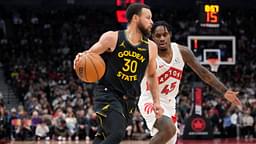 Golden State Warriors guard Stephen Curry (30) dribbles past Toronto Raptors guard Davion Mitchell (45) during the second half at Scotiabank Arena.