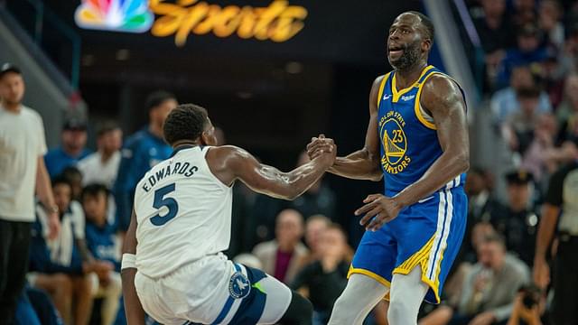 Golden State Warriors forward Draymond Green (23) helps up Minnesota Timberwolves guard Anthony Edwards (5) after being knocked down during the second quarter at Chase Center.