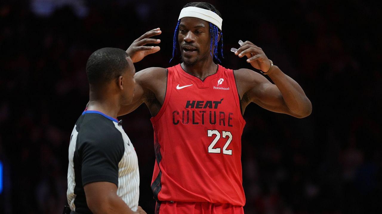 Miami Heat forward Jimmy Butler (22) talks with official Dedric Taylor during a timeout in the second half against the Phoenix Suns at Kaseya Center.