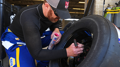 NAPA Autocare Chevrolet front tire changer Aaron Powell greases lug nuts n a wheel ahead of the NASCAR truck series race at the Circuit of the Americas on Saturday Mar. 25, 2023 in Austin.