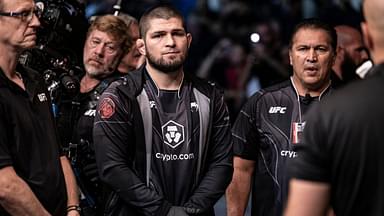 Khabib Nurmagomedov is seen before the fight between Abubakar Nurmagomedov (red gloves) and Gadzhi Omargadzhiev (blue gloves) during UFC 280 at Etihad Arena.