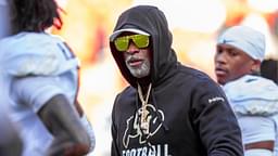 Colorado head coach Deion Sanders watches his players warmup prior to the game between the Kansas Jayhawks and the Colorado Buffaloes at GEHA Field at Arrowhead Stadium.