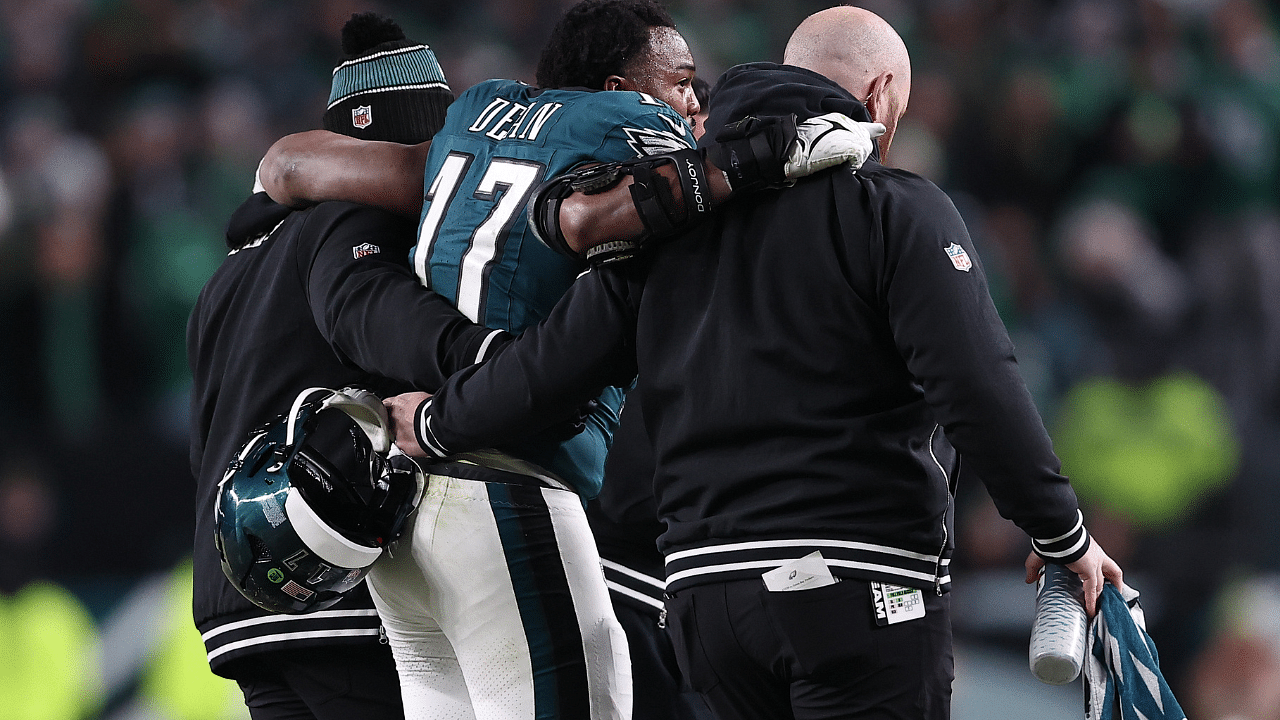 Philadelphia Eagles linebacker Nakobe Dean (17) is helped off the field against the Green Bay Packers during the first half in an NFC wild card game at Lincoln Financial Field.