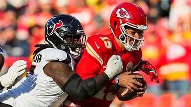 Dec 21, 2024; Kansas City, Missouri, USA; Kansas City Chiefs quarterback Patrick Mahomes (15) is tackled by Houston Texans defensive tackle Mario Edwards Jr. (97) during the first half at GEHA Field at Arrowhead Stadium.