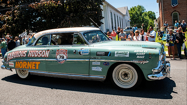 Driver Neil Socquet from Westlake Village, CA, drives a 1952 Hudson Hornet down Clinton street along with his navigators during the Great Race stop in Montgomery, NY on Sunday, June 19, 2022. Ekmgreatrace19