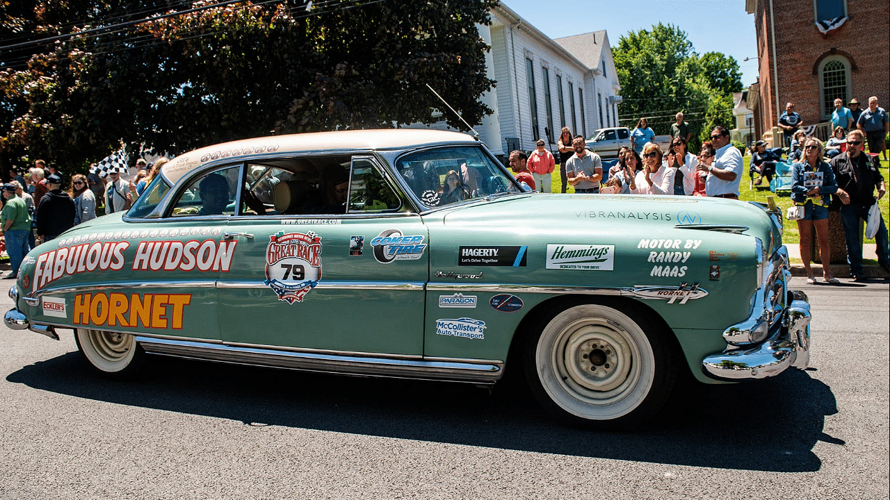 Driver Neil Socquet from Westlake Village, CA, drives a 1952 Hudson Hornet down Clinton street along with his navigators during the Great Race stop in Montgomery, NY on Sunday, June 19, 2022. Ekmgreatrace19