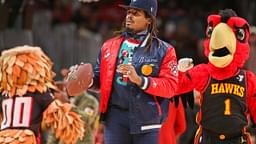 Former NFL quarterback Cam Newton on the court during a game between the Atlanta Hawks and Detroit Pistons in the second quarter at State Farm Arena.