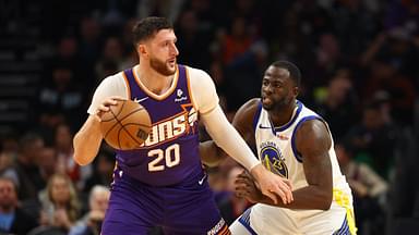 Golden State Warriors forward Draymond Green (23) defends against Phoenix Suns center Jusuf Nurkic (20) at Footprint Center