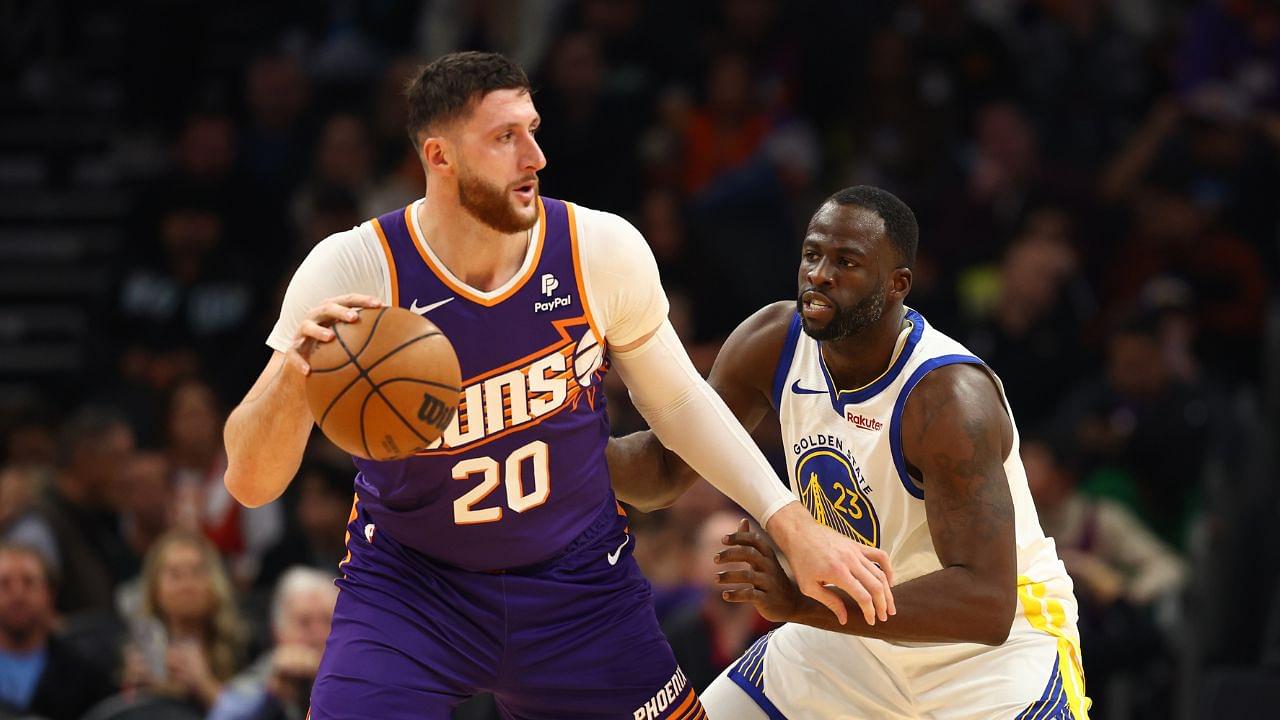 Golden State Warriors forward Draymond Green (23) defends against Phoenix Suns center Jusuf Nurkic (20) at Footprint Center