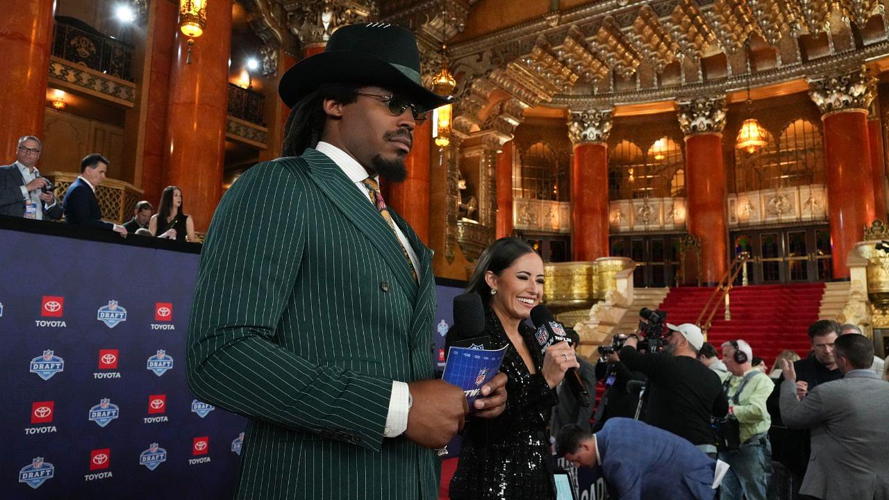 Former NFL quarterback Cam Newton and broadcaster Kaylee Hartung stand on the red carpet ahead of the 2024 NFL Draft at Detroit’s Fox Theatre.