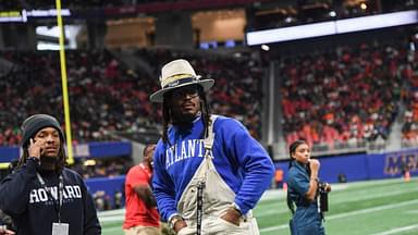 Former Auburn and NFL star Cam Newton stands on the sidelines during the Cricket Celebration Bowl game between Florida A&M University and Howard University at Mercedes-Benz Stadium in Atlanta