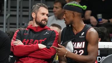 Miami Heat forward Jimmy Butler (22) talks with forward Kevin Love (42) on the bench during the second half against the Indiana Pacers at Kaseya Center.