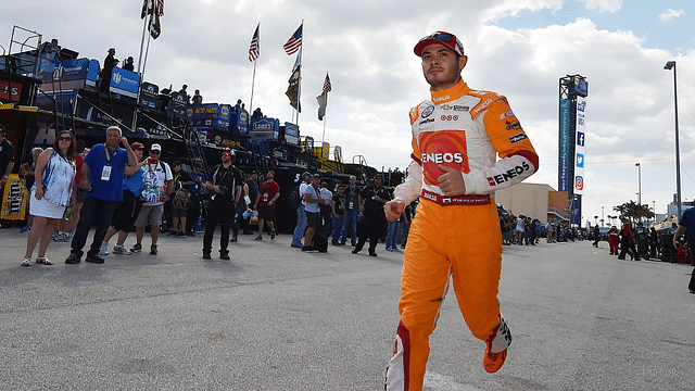 NASCAR Sprint Cup Series driver Kyle Larson (42) runs through the garage area during practice for the Ford Ecoboost 400 at Homestead-Miami Speedway.