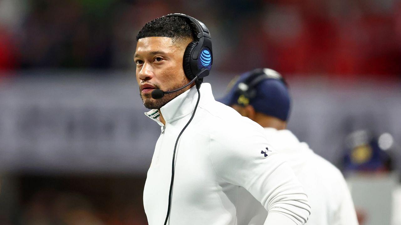 Notre Dame Fighting Irish head coach Marcus Freeman looks on against the Ohio State Buckeyes during the first half the CFP National Championship college football game at Mercedes-Benz Stadium.