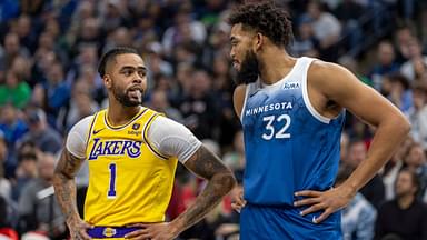 Los Angeles Lakers guard D'Angelo Russell (1) and Minnesota Timberwolves center Karl-Anthony Towns (32) talk during a free throw in the first half at Target Center