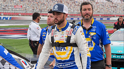 May 25, 2024; Concord, North Carolina, USA; NASCAR Cup Series driver Chase Elliott (9) walks with his car during qualifying at Charlotte Motor Speedway. Mandatory Credit: Jim Dedmon-Imagn Images