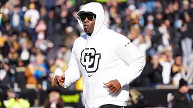 Colorado Buffaloes head coach Deion Sanders runs onto the field before the game against the Oklahoma State Cowboys at Folsom Field.