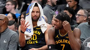 Golden State Warriors guard Stephen Curry (30) and guard Buddy Hield (7) talk on the bench during the second half against the Toronto Raptors at Scotiabank Arena.