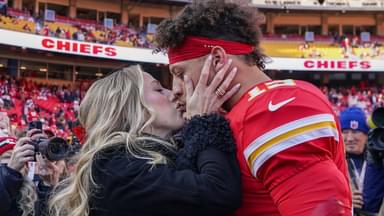 Kansas City Chiefs quarterback Patrick Mahomes (15) kisses his wife Brittany prior to a game against the Las Vegas Raiders at GEHA Field at Arrowhead Stadium.