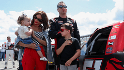 Jul 22, 2023; Long Pond, Pennsylvania, USA; NASCAR Craftsman Truck Series driver Kyle Busch stands with his wife Samantha Busch and children Brexton and Lennix prior to the CRC Brakleen 150 at Pocono Raceway. Mandatory Credit: Matthew O'Haren-Imagn Images