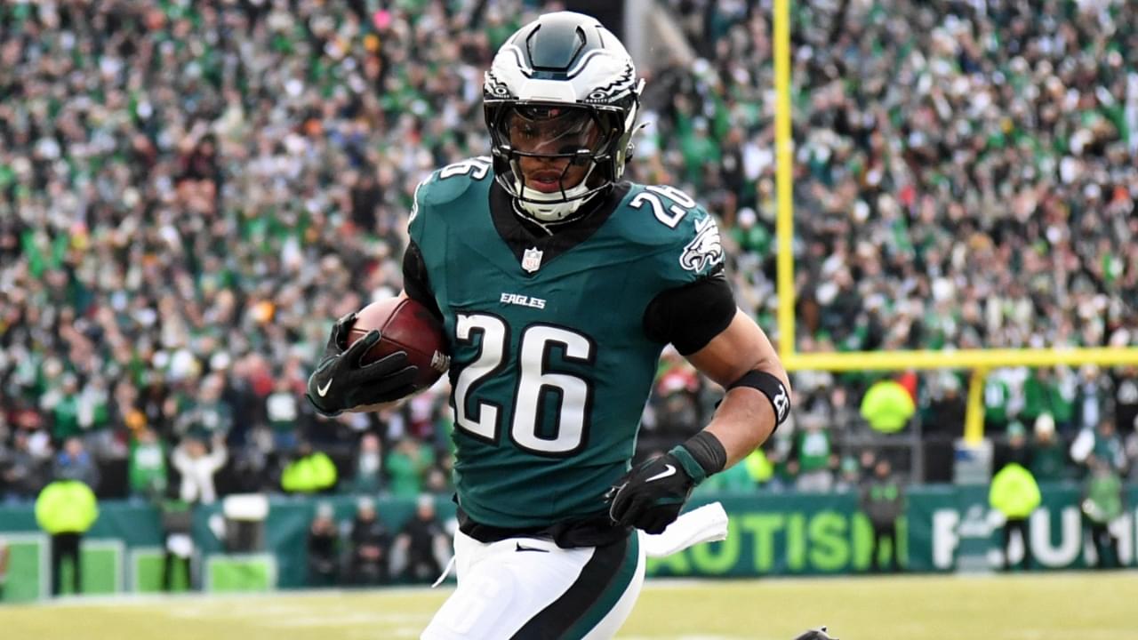 Jan 26, 2025; Philadelphia, PA, USA; Philadelphia Eagles running back Saquon Barkley (26) runs with the ball for a touchdown against the Washington Commanders during the first half in the NFC Championship game at Lincoln Financial Field.