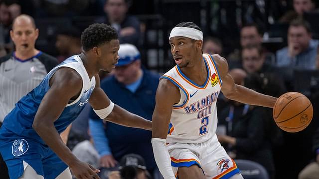 Oklahoma City Thunder guard Shai Gilgeous-Alexander (2) looks to pass the ball as Minnesota Timberwolves guard Anthony Edwards (5) plays defense in the second half at Target Center.