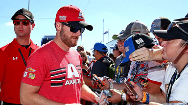 NASCAR Cup Series driver Dale Earnhardt Jr. (88) signs autographs before the Ford EcoBoost 400 at Homestead-Miami Speedway.