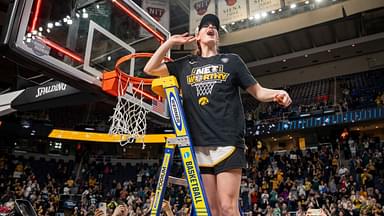 Iowa Hawkeyes guard Caitlin Clark (22) cuts down the net after beating LSU in the Elite 8 round of the NCAA Women's Basketball Tournament between Iowa and LSU at MVP Arena