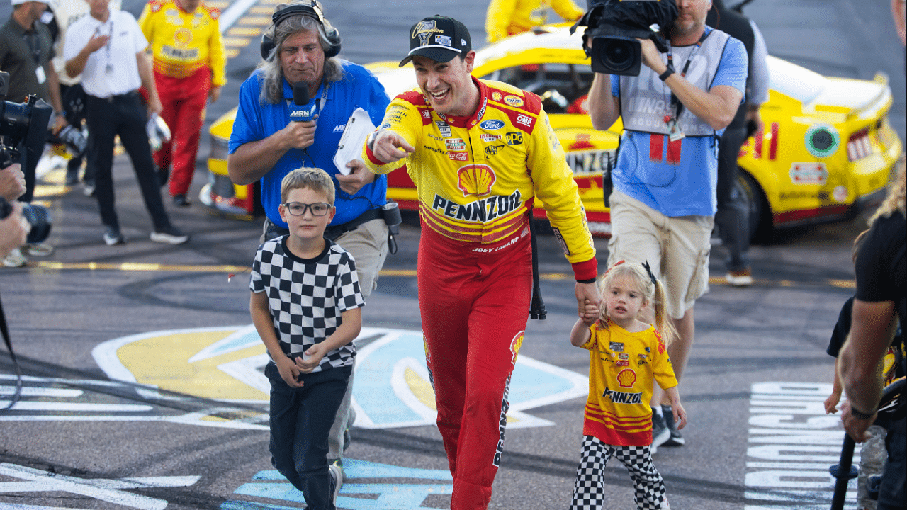 Nov 10, 2024; Avondale, Arizona, USA; NASCAR Cup Series driver Joey Logano (22) celebrates with his children after winning the 2024 NASCAR Cup Series championship and the NASCAR Cup Series Championship race at Phoenix Raceway. Mandatory Credit: Mark J. Rebilas-Imagn Images