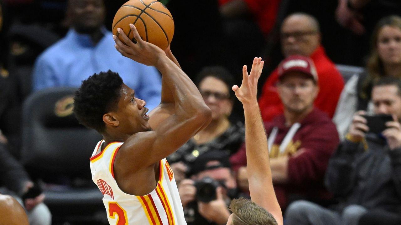 Atlanta Hawks forward De'Andre Hunter (12) shoots beside Cleveland Cavaliers guard Sam Merrill (5) in the fourth quarter at Rocket Mortgage FieldHouse