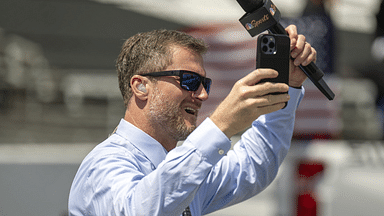 Dale Earnhardt Jr. raises his hands to cheering fans on the grid before the Verizon 200 at the Indianapolis Motor Speedway Road Course.