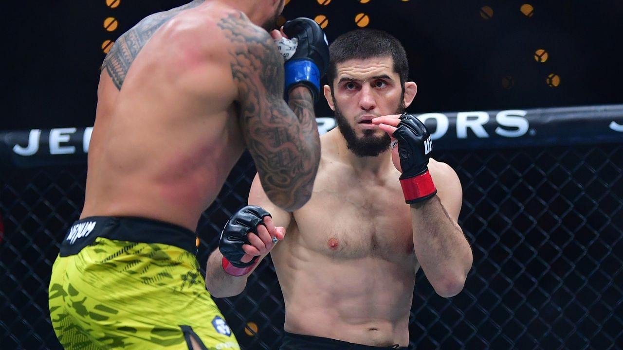 Islam Makhachev (red gloves) fights Renato Moicano (blue gloves) in a lightweight title fight during UFC 311 at Intuit Dome.