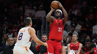 Miami Heat forward Jimmy Butler (22) shoots the ball against Phoenix Suns guard Grayson Allen (8) during the second half at Kaseya Center.