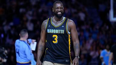 Former Marquette Golden Eagles player Dwyane Wade smiles timeout during the first half of the game against the Providence Friars at Fiserv Forum