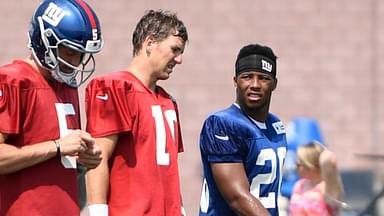 Aug 7, 2018; East Rutherford, NJ, USA; New York Giants quarterback Eli Manning (10) and rookie running back Saquon Barkley (26) talk on the field during training camp.