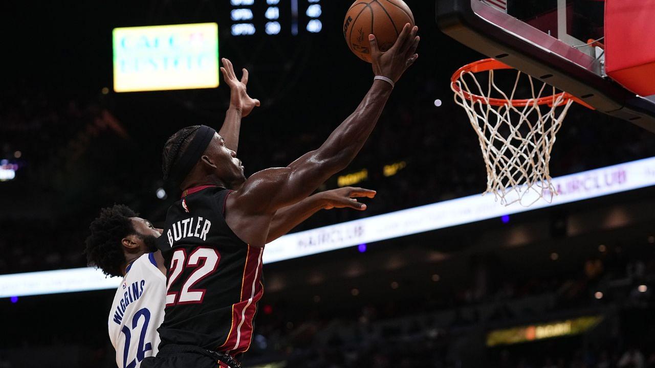 Miami Heat forward Jimmy Butler (22) shoots the ball around Golden State Warriors forward Andrew Wiggins (22) during the second half at FTX Arena.