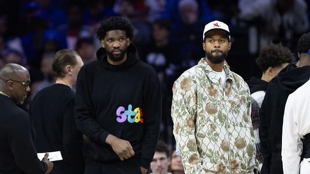 Injured Philadelphia 76ers Paul George (R) and Joel Embiid (L) look on during the first quarter against the Memphis Grizzlies at Wells Fargo Center