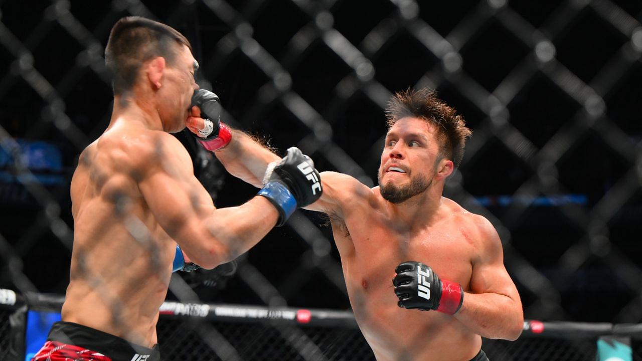 Henry Cejudo (red gloves) fights Song Yadong (blue gloves) in the bantamweight bout during UFC Fight Night at Climate Pledge Arena.