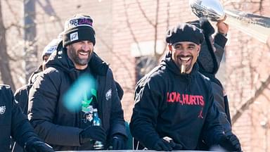 Philadelphia Eagles owner, Jeffrey Lurie, left, joins head coach Nick Sirianni and quarterback Jalen Hurts atop one of the team buses during the Super Bowl 59 victory parade along S. Broad Street in Philadelphia, PA, on Friday, Feb. 14, 2025.