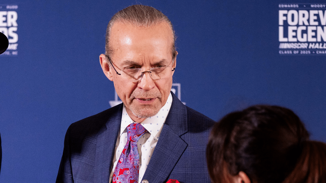 Feb 7, 2025; Charlotte, NC, USA; Former NASCAR drivers Richard Petty shows off custom vest with his son Kyle Petty on the red carpet before the 2025 NASCAR Hall of Fame Induction Ceremony at Charlotte Convention Center Crown Ballroom. Mandatory Credit: Scott Kinser-Imagn Images