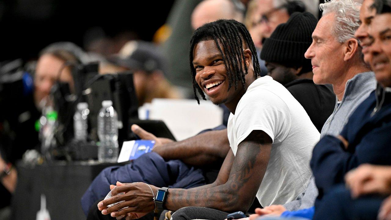 2024 Heisman Trophy winner Travis Hunter Jr. laughs during the second half of the game between the Dallas Mavericks and the Minnesota Timberwolves at the American Airlines Center.