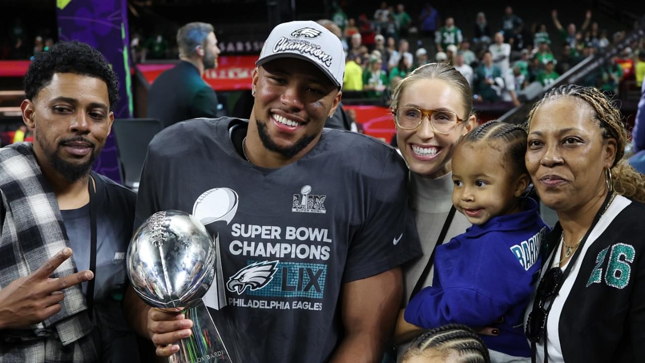 Feb 9, 2025; New Orleans, LA, USA; Philadelphia Eagles running back Saquon Barkley holds the Lombardi Trophy with his family after the championship trophy presentation after the Eagles' game against the Kansas City Chiefs in Super Bowl LIX at Caesars Superdome.