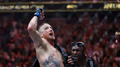 Justin Gaethje (blue gloves) reacts to defeating Dustin Poirier (red gloves) during UFC 291 at Delta Center.