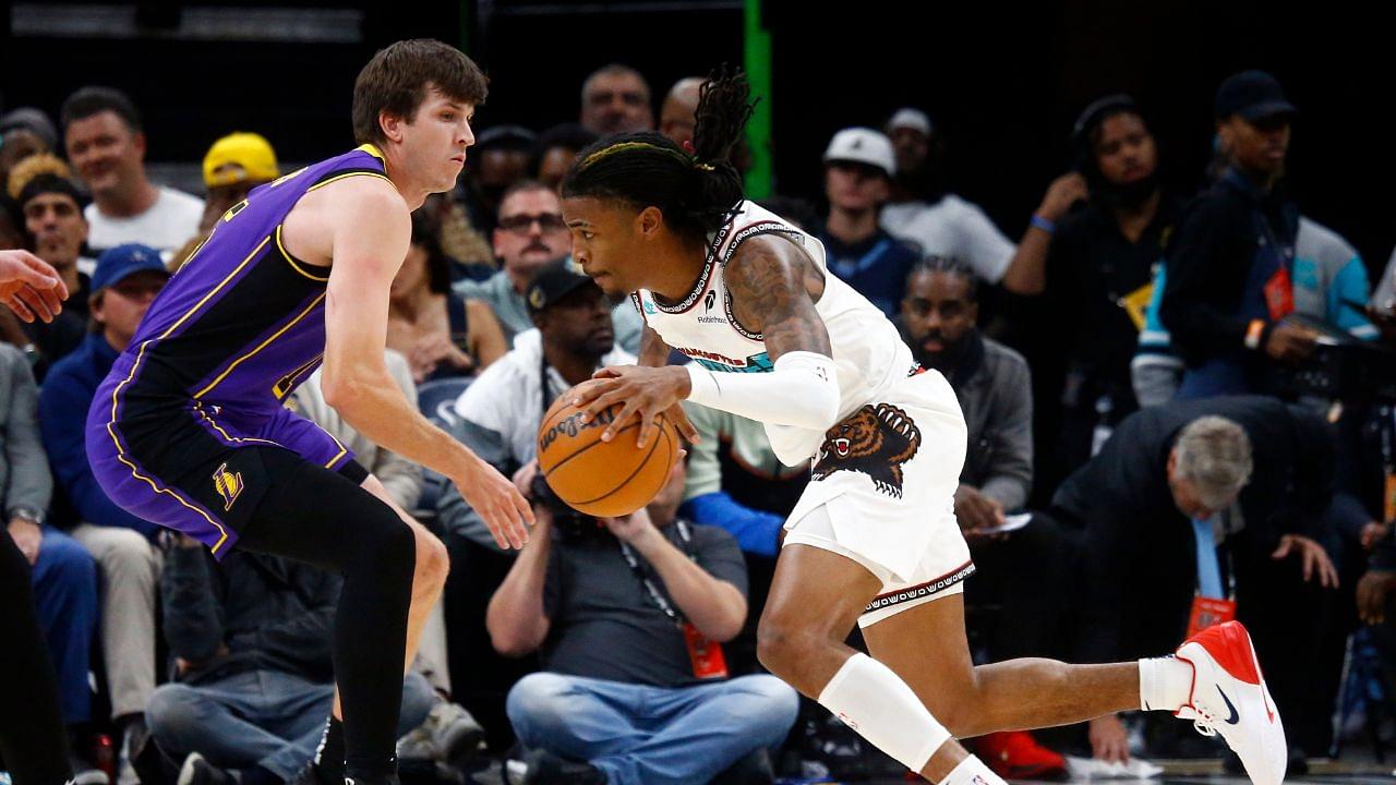 Memphis Grizzlies guard Ja Morant (12) drives to the basket around Los Angeles Lakers guard Austin Reaves (15) during the first half at FedExForum