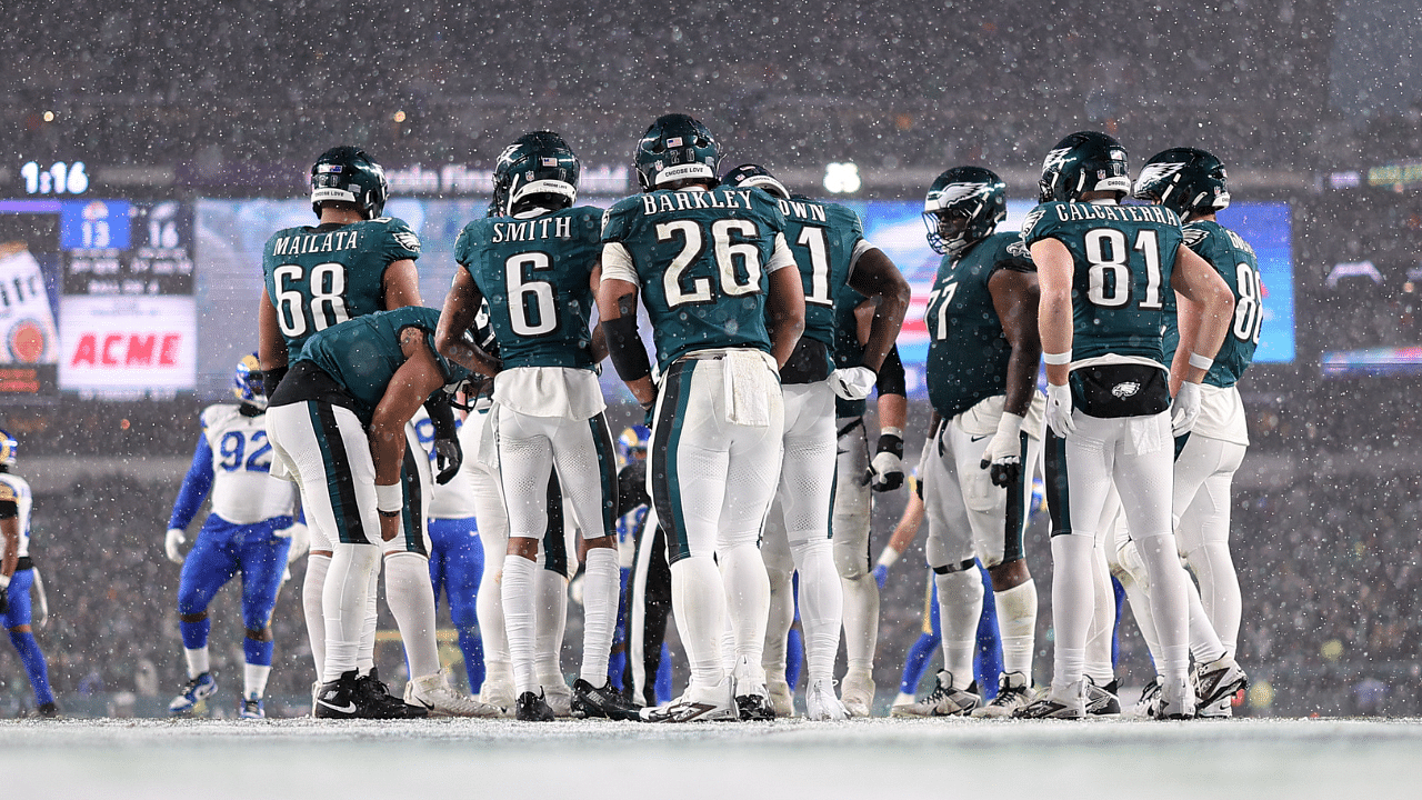 Philadelphia Eagles running back Saquon Barkley (26) and his team huddle up for a play against the Los Angeles Rams in a 2025 NFC divisional round game at Lincoln Financial Field.