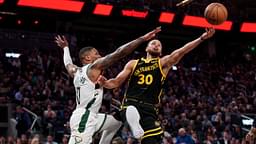 Golden State Warriors guard Stephen Curry (30) shoots the ball while being defended by Milwaukee Bucks guard Damian Lillard (0) in the third quarter at the Chase Center.